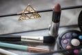 Brushes for cosmetics, eye shadows, lipstick, hairpin on glass stand