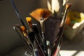 brushes of different size and thickness inside a ceramic container on a table Royalty Free Stock Photo
