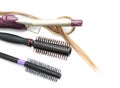 Brushes, hair curler and strand on white background