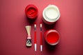 Brushes and jars with paint on red background, flat lay. Space for text AI Generated