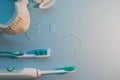 Brushes, model of the jaw and dental floss on a blue background Royalty Free Stock Photo