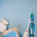 Brushes, model of the jaw and dental floss on a blue background Royalty Free Stock Photo
