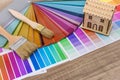 Brushes and paint color palette samples on wooden background, closeup Royalty Free Stock Photo