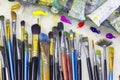 Brushes for painting and colored oil paints lie on palette in the artist`s studio Royalty Free Stock Photo