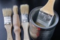 Brushes for painting with paint and cans on a workshop table. Painting accessories prepared for painting Royalty Free Stock Photo