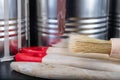 Brushes for painting with paint and cans on a workshop table. Painting accessories prepared for painting Royalty Free Stock Photo