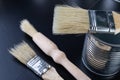 Brushes for painting with paint and cans on a workshop table. Painting accessories prepared for painting Royalty Free Stock Photo