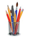 Brushes, pencils and pens in the holder.