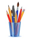 Brushes, pencils and pens in the holder.