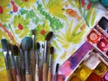 Brushes, watercolor, drawings on the table