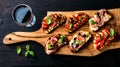 Brushetta set and glass of red wine. Small sandwiches with prosciutto, tomatoes, parmesan cheese, fresh basil, balsamic