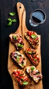 Brushetta set and glass of red wine. Small sandwiches with prosciutto, tomatoes, parmesan cheese, fresh basil, balsamic Royalty Free Stock Photo