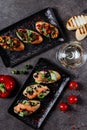 Brushetta set for wine. Variety of small sandwiches with prosciutto, tomatoes, parmesan cheese, fresh basil and balsamic Royalty Free Stock Photo