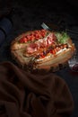 Brushetta set for wine. Variety of small sandwiches with prosciutto, tomatoes, parmesan cheese, fresh basil and balsamic Royalty Free Stock Photo