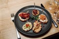 Brushetta set for wine. Variety of small sandwiches with prosciutto, tomatoes, parmesan cheese, fresh basil and balsamic Royalty Free Stock Photo