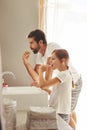 Brushing teeth, dad and young child in a bathroom at home in morning with dental cleaning. Oral hygiene, kids and father