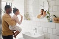 Brushing teeth, father and child in home bathroom for dental health and cleaning in mirror. African man, girl kid or Royalty Free Stock Photo