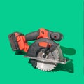 A brushless cordless circular saw on beautiful green background with sunny shadow Royalty Free Stock Photo