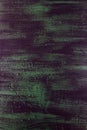 Brushstrokes with thick paint in shades of green, blue, purple on old wooden texture