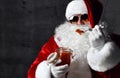 Brusque Santa Claus in aviator sunglasses is eating red caviar fish salmon. New year and Merry Christmas concept