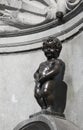 Brussels, B, Belgium - August 18, 2022: Manneken Pis is famous a fountain with a statue of boy Royalty Free Stock Photo