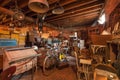 Attic of old antique store with many vintage utensil, decor, wooden furniture, retro bicycle and many details