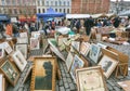 Many paintings for sale on outdoor flea market with old bargains, antique stuff, vintage decor, retro furniture