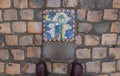 Mosaic artwork with gas lantern and moon at night, on cobbled stone street of old city