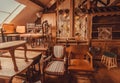 Old shelves and wooden furniture in historical house with vintage chairs and decoration Royalty Free Stock Photo