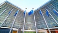 European Union EU flags waving in front of the Berlaymont building, headquarters of the European Commission in Brussels.