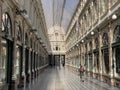 Brussels, Belgium, April 25, 2020 - one people walking alone inside the luxury glazed shopping arcade Les Galeries Royales Saint-