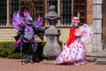 Two artists wearing venetian costumes and masks, Brussels Floralia