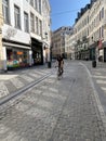 Brussels, Belgium, April 25, 2020 - .Rue marchÃÂ© aux herbes, a family cyclists on a deserted street in the old quarter of Brussels