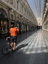 Brussels, Belgium, April 25, 2020 - two cyclist inside the empty luxury glazed shopping arcade Les Galeries Royales Saint-Hubert