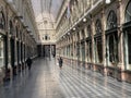 Brussels, Belgium, April 25, 2020 - two people inside the luxury glazed shopping arcade Les Galeries Royales Saint-Hubert during Royalty Free Stock Photo