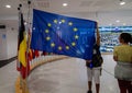 Brussels, Belgium, August 2019. At the headquarters of the European Parliament: the flags of the member states. A boy raises that Royalty Free Stock Photo