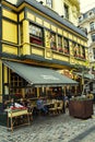 Brussels, Belgium, 10/13/2019: Beautiful facade of a cafe with visitors in the European old town.