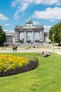 Brussels - Belgium - The cinquantenaire city park with a fountain, colorful flowers and the symbolic arcades in the background