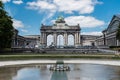Brussels - Belgium - The cinquantenaire city park with a fountain, colorful flowers and the symbolic arcades in the background