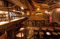 Empty bar with old schooner interior, old barrels, wooden furniture and pub counter without bartenders Royalty Free Stock Photo