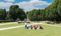 Brussels- Belgium -- Mixed group of people sitting in the green lawns of the cinquentenaire city park