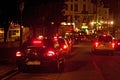 BRUSSELS, BELGIUM - SEPTEMBER 06, 2014: Night view of a black taxi cars parked on roadside.