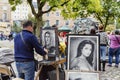 Brussels, Belgium, 10/13/2019: A street artist paints portraits of tourists on a square in the city center