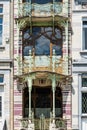 Brussels, Belgium - Typical art nouveau facade with shaped metal ornaments, round windows, arches