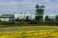 Brussels, Belgium view over green meadows with buttercups and city buildings in the background