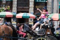 Brussels Old Town, Belgium - Traditional horse and carriage at Grande Place with a young Japanese boy looking astonished