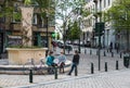 Brussels old Town, brussels Capital Region - Belgium - Three attractive fashionable teenage girls sitting on a city fountain