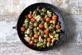 Brussels sprouts with vegetables and herbs in a pan. Cooking Brussels sprouts. Vegan food. Selective focus. Royalty Free Stock Photo