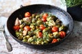Brussels sprouts with vegetables and herbs in a pan. Cooking Brussels sprouts. Vegan food. Selective focus. Royalty Free Stock Photo