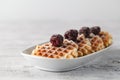 Brussels waffles with blackberries on white plate Royalty Free Stock Photo